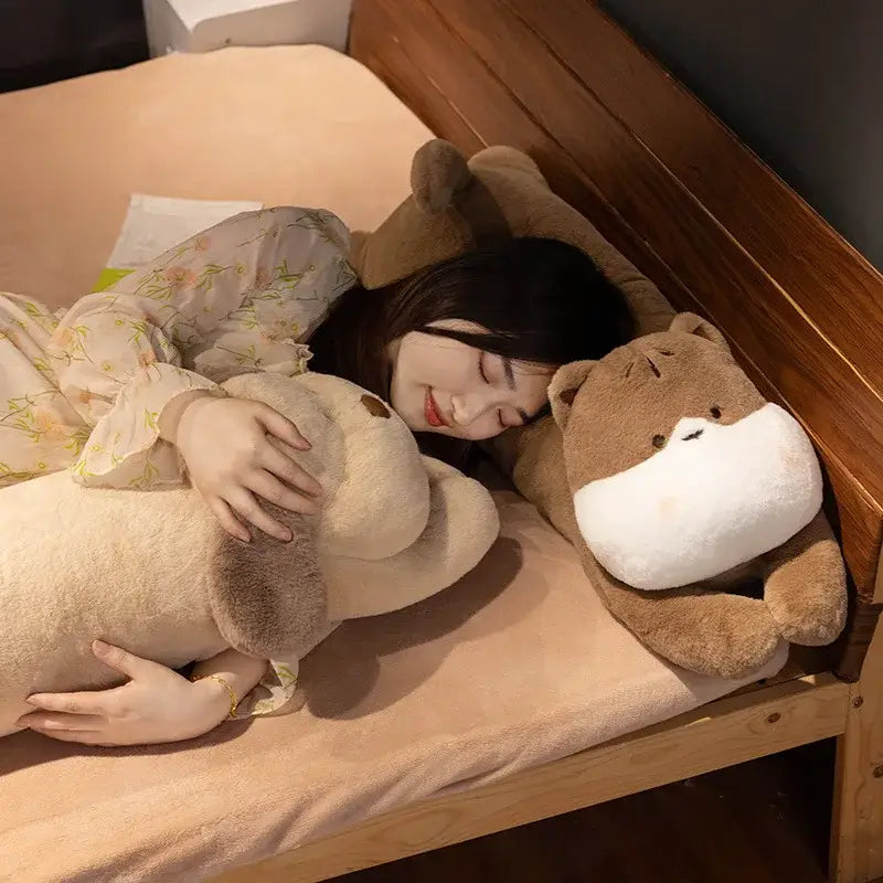Soft beige and brown plush otter-shaped decorbites dog sleeper body pillow with white snout and black button eyes for leg support