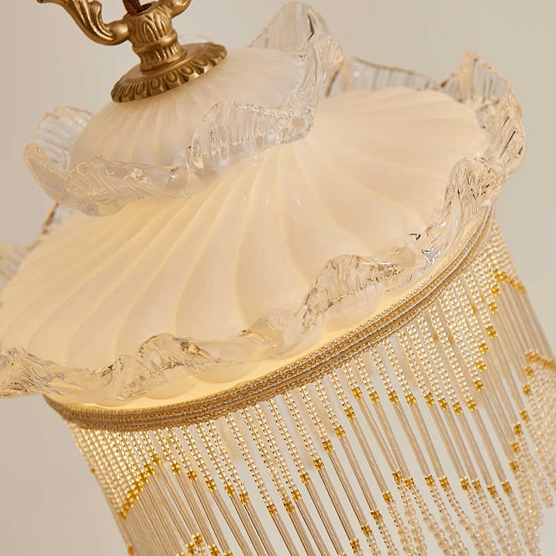 Vintage-style tassel chandelier with cream lace lampshade and clear glass base for dining room use