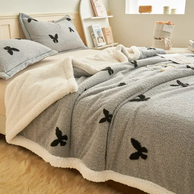 Taupe wool blanket with black butterfly jacquard appliqués and soft white fleece lining for cozy bedroom decorbites