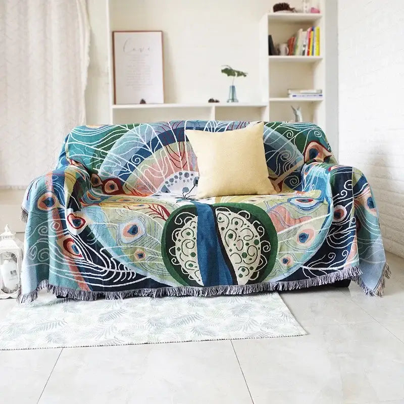 Vibrant teal and blue peacock knit sofa blanket cover with fringe edges perfect for decorbites knit sofa decor