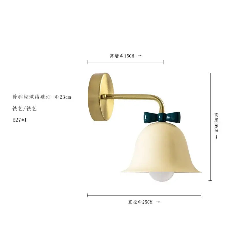 A brass-finished wall lamp with a cream bell-shaped shade and dark teal bow for decorbites bowknot bell wall decor