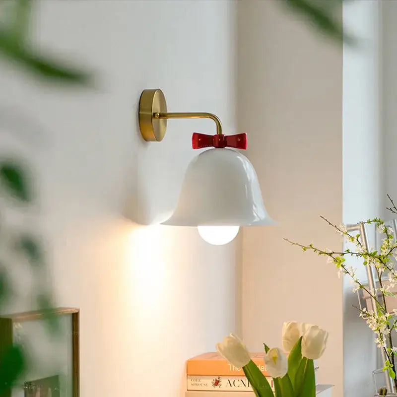 White ceramic bell-shaped wall lamp with gold-finished metal arm and red bow decorbites bowknot bell wall accent