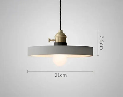 Minimalist gray pendant light with brass industrial fixture and exposed bulb complementing decorbites blue glass pendant lights