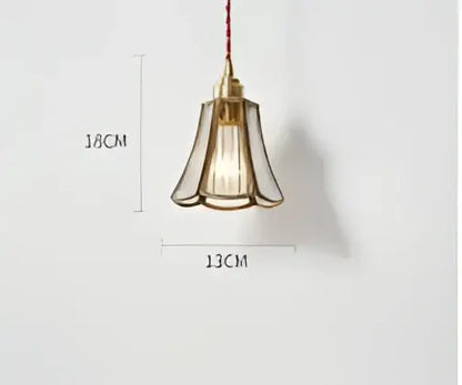Teal blue glass pendant light with brass hardware featuring a fluted glass shade and exposed filament bulb for dining room decorbites blue glass pendant lights