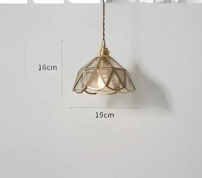 Teal blue glass pendant light with delicate brass hardware and lace-like petal-shaped shade for dining room decorbites blue glass pendant lights