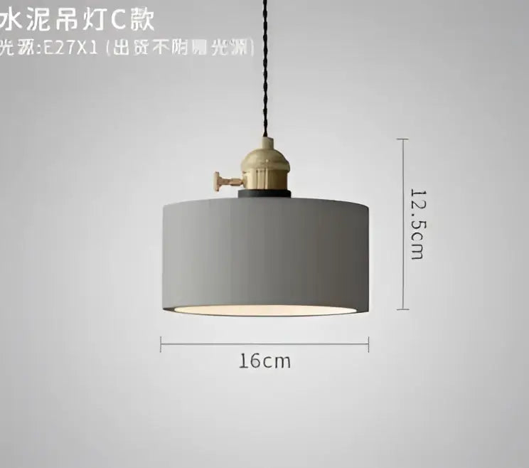 Gray cylindrical pendant light with brass-finished metal fixture and black cord complementing decorbites blue glass pendant lights
