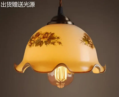 Teal blue glass pendant light with brass hardware and warm-toned floral decal bulb for dining room decorbites blue glass pendant lights