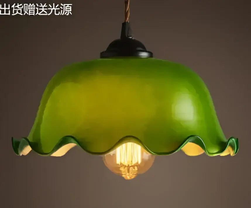 Teal blue glass pendant light with brass hardware featuring a green wavy glass design and exposed filament bulb for dining room decorbites blue glass pendant lights