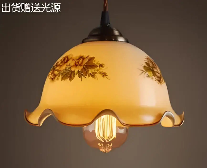 Teal blue glass pendant light with brass hardware featuring warm-toned floral decals and vintage bulb for dining room decorbites blue glass pendant lights