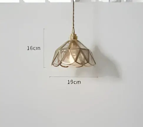 A teal blue glass pendant light with brass hardware and a delicate lace-like petal-shaped shade for dining room decorbites blue glass pendant lights