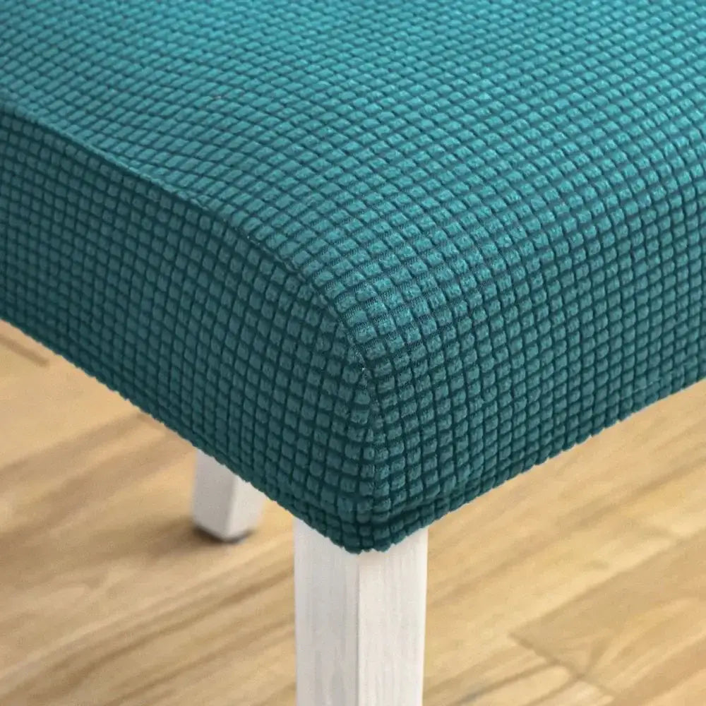 Teal blue quilted chair cover with textured stretch fabric and woven grid pattern for dining room decorbites chair cover