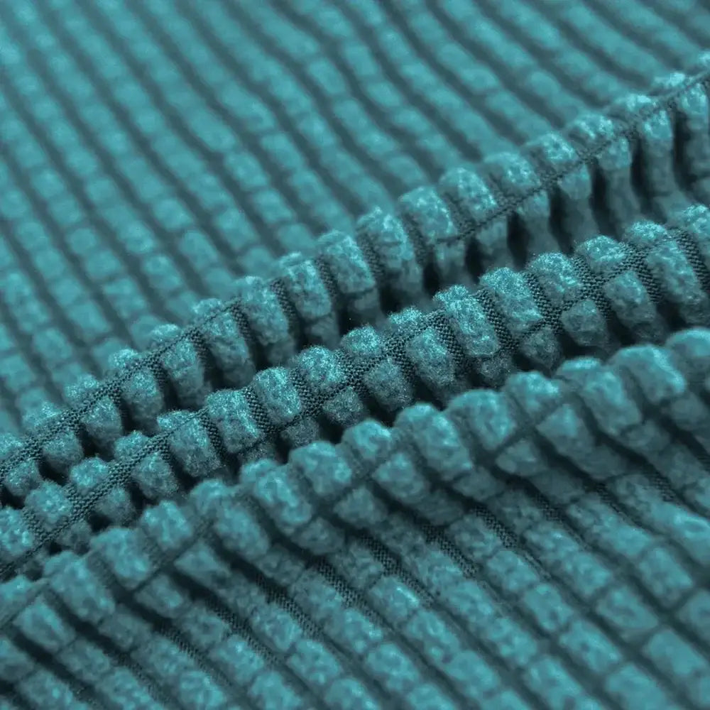 Teal blue quilted chair cover made of soft plush corduroy fabric with stretch elastic for dining room protection