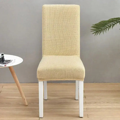 Beige textured stretch chair cover with subtle grid pattern complementing decorbites blue quilted chair protector