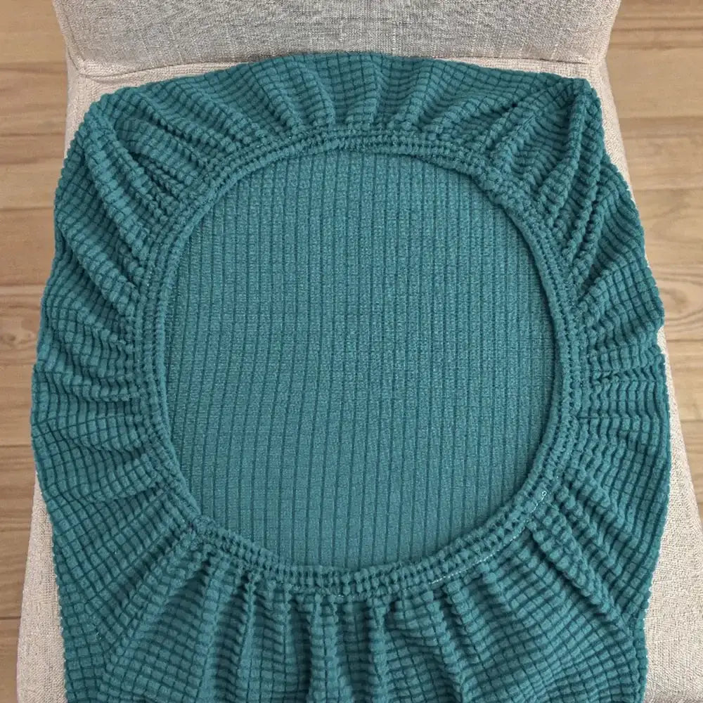 Teal blue quilted chair cover with ribbed elastic stretch fabric for dining room protector by decorbites