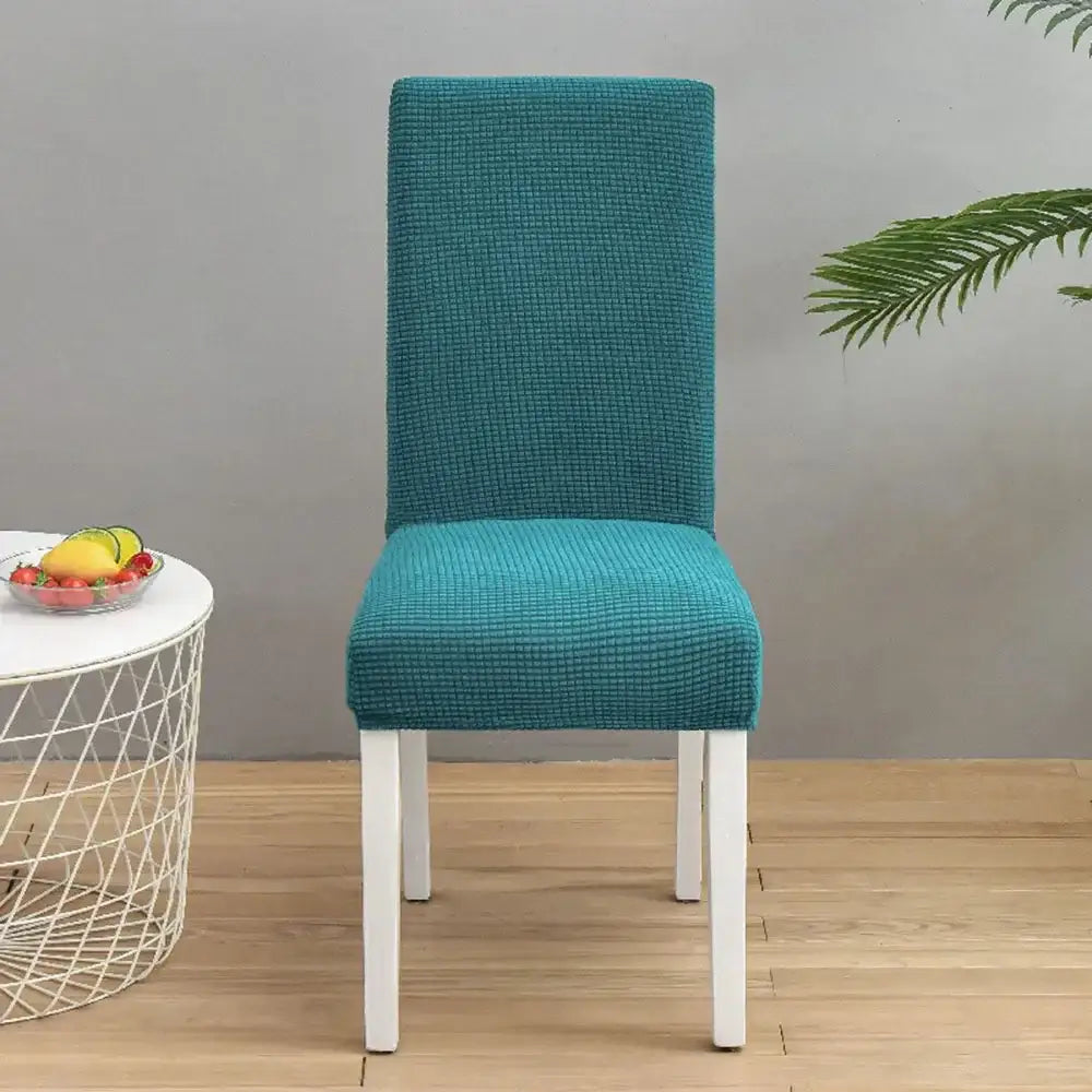 Teal blue quilted chair cover with stretch elastic fabric for dining room protection by decorbites