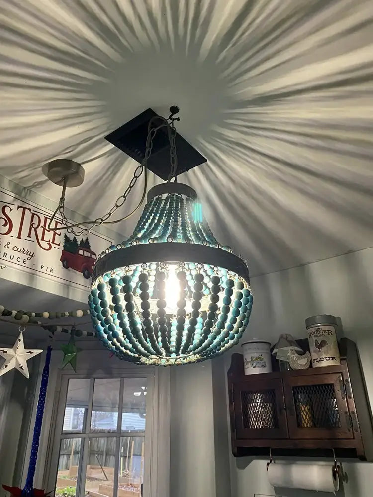 Teal blue wood beads pendant light with dark metal frame and chain suspension featuring decorbites blue wood beads