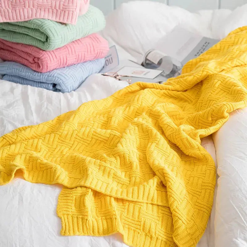 Bright yellow knitted throw blanket with textured woven pattern as a decorbites cozy jacquard living room throw
