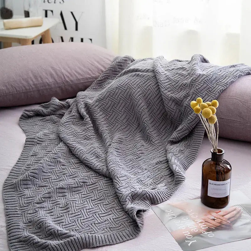 Gray knitted throw blanket with textured herringbone pattern for decorbites cozy jacquard living room throw