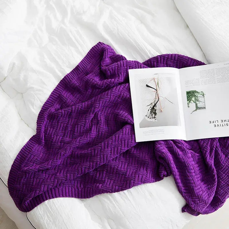 A plush deep purple knitted throw blanket with textured herringbone pattern decorbites cozy jacquard blanket