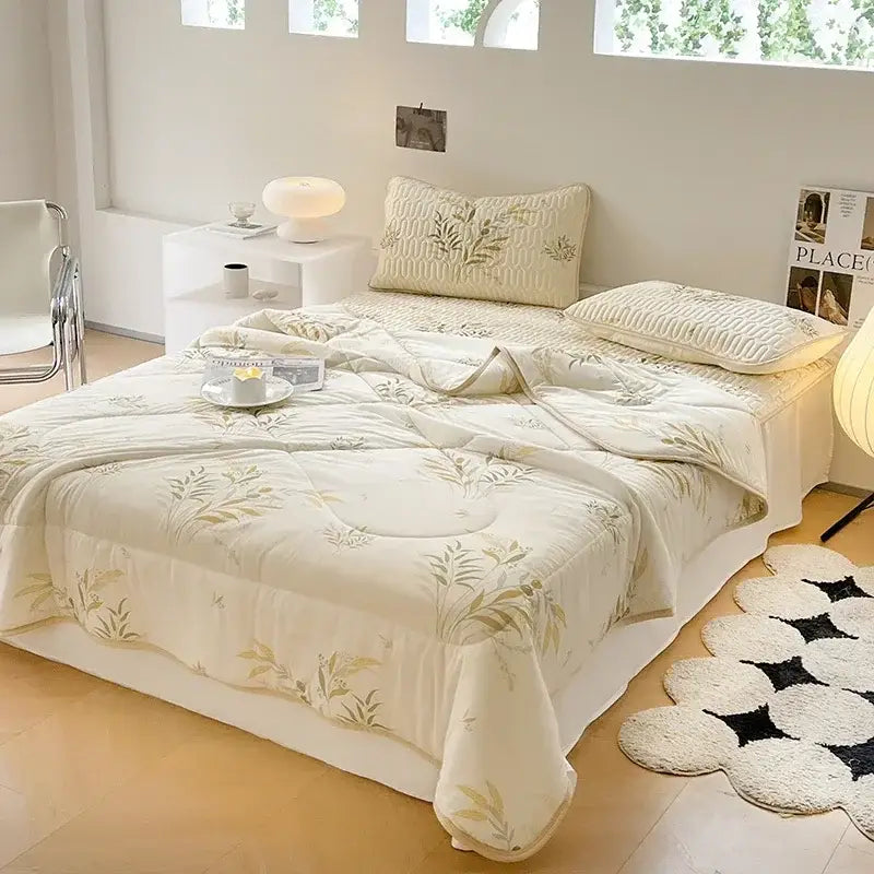 Cream-colored quilt with gold leaf embroidery and plush texture in the decorbites cool summer blanket set