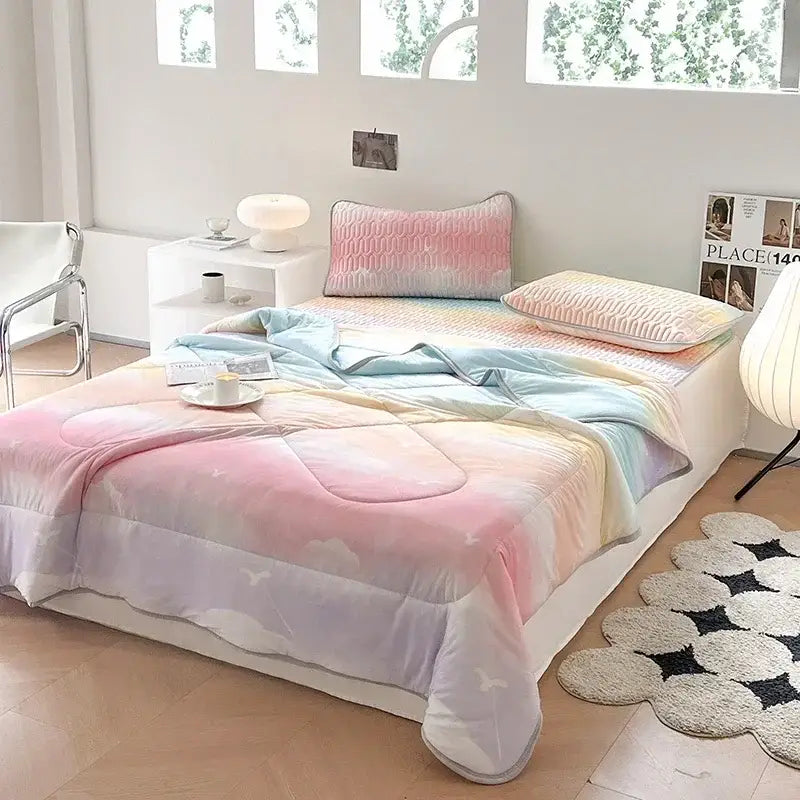 Pastel rainbow gradient quilt with soft cloud patterns and subtle stitching in teal and cream decorbites cool summer blanket set