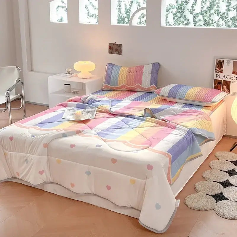Teal and cream zigzag cool summer blanket set with rainbow-striped quilt and pastel heart patterns on plush white base