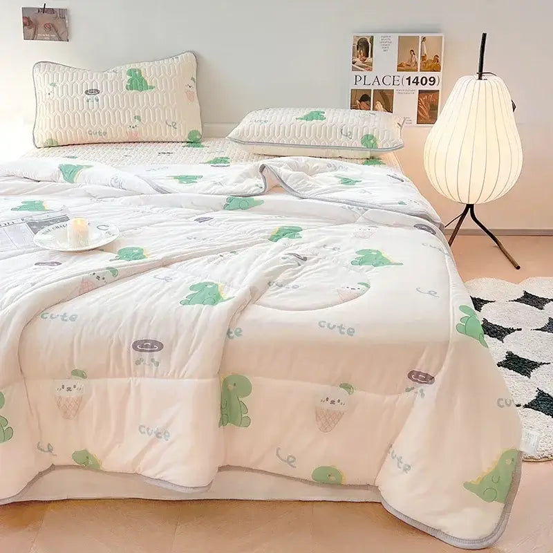 A cream-colored cool summer blanket set with green dinosaur pattern and light gray cute lettering for decorbites bedroom
