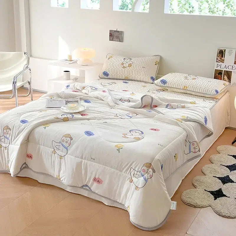 White quilted comforter with cartoon duck and flower patterns in pastel colors soft cotton texture decorbites cool summer blanket set