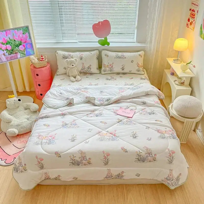White quilt from the teal and cream zigzag decorbites cool summer blanket set featuring pastel floral and bunny pattern