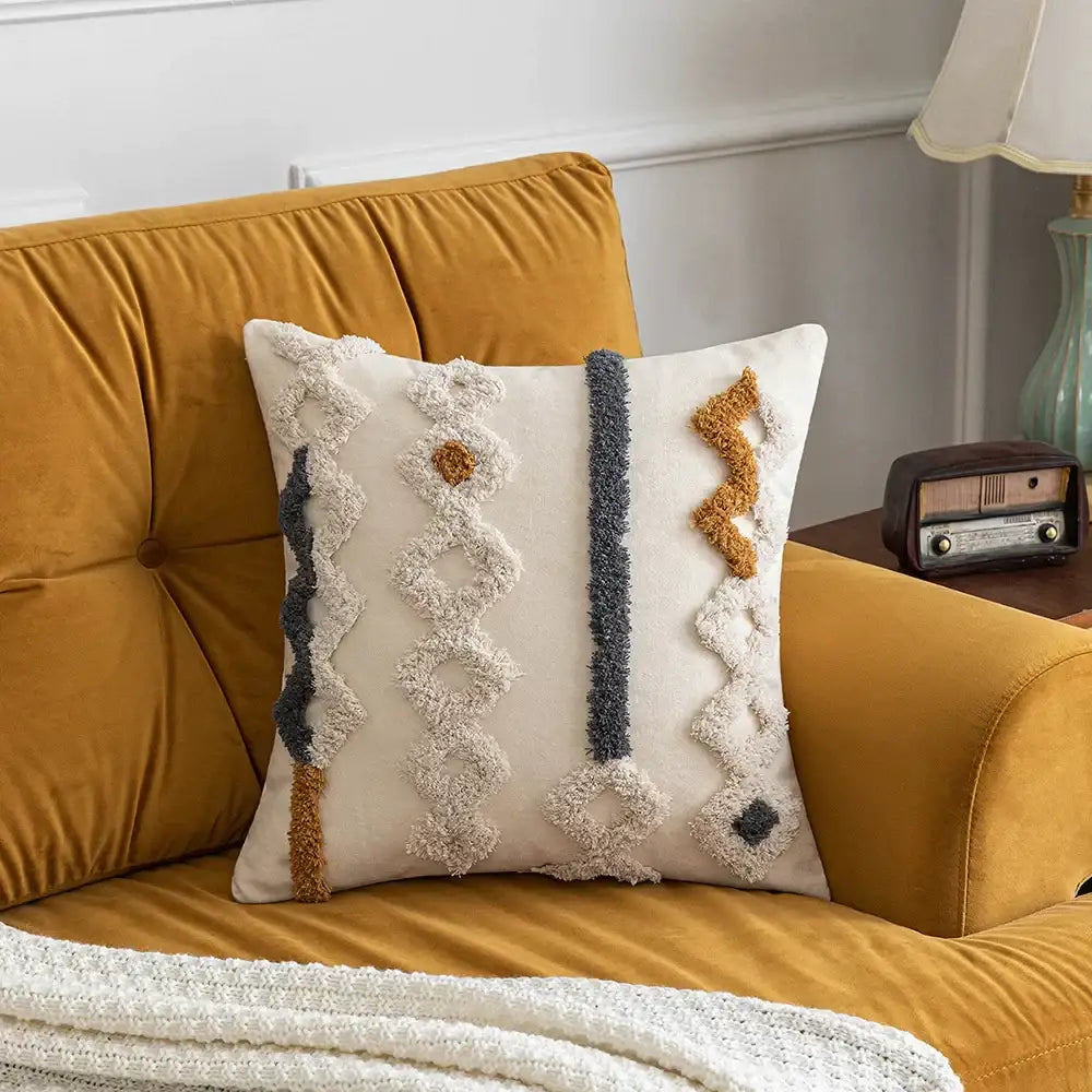 Cream-colored decorbites boho tufted pillow cover with woven geometric patterns in beige dark gray and mustard yellow
