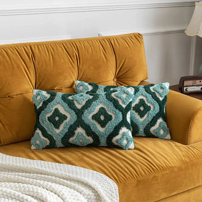 Two teal and white geometric pillow covers on a mustard-yellow velvet sofa featuring decorbites boho tufted design