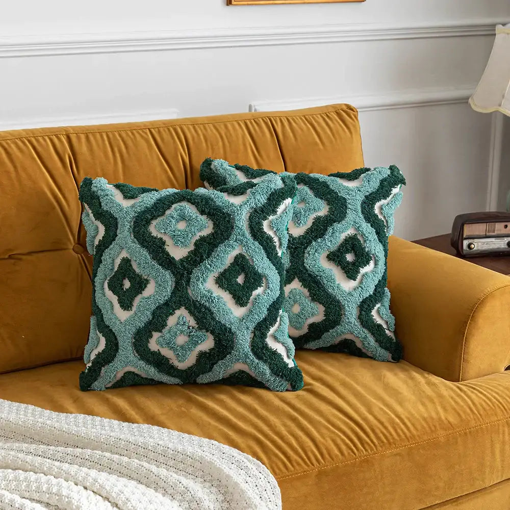 Two plush teal and dark green decorbites boho tufted pillow covers with cream geometric patterns for living room decor