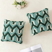 Two square pillow covers with plush teal and dark green embroidered zigzag pattern on cream for decorbites boho tufted decor