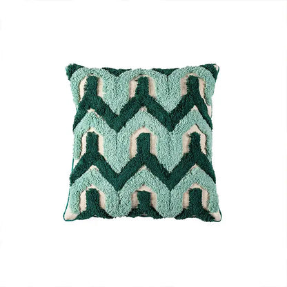 A plush teal and dark green cushion case with cream accents featuring decorbites geometric embroidery tassel pattern