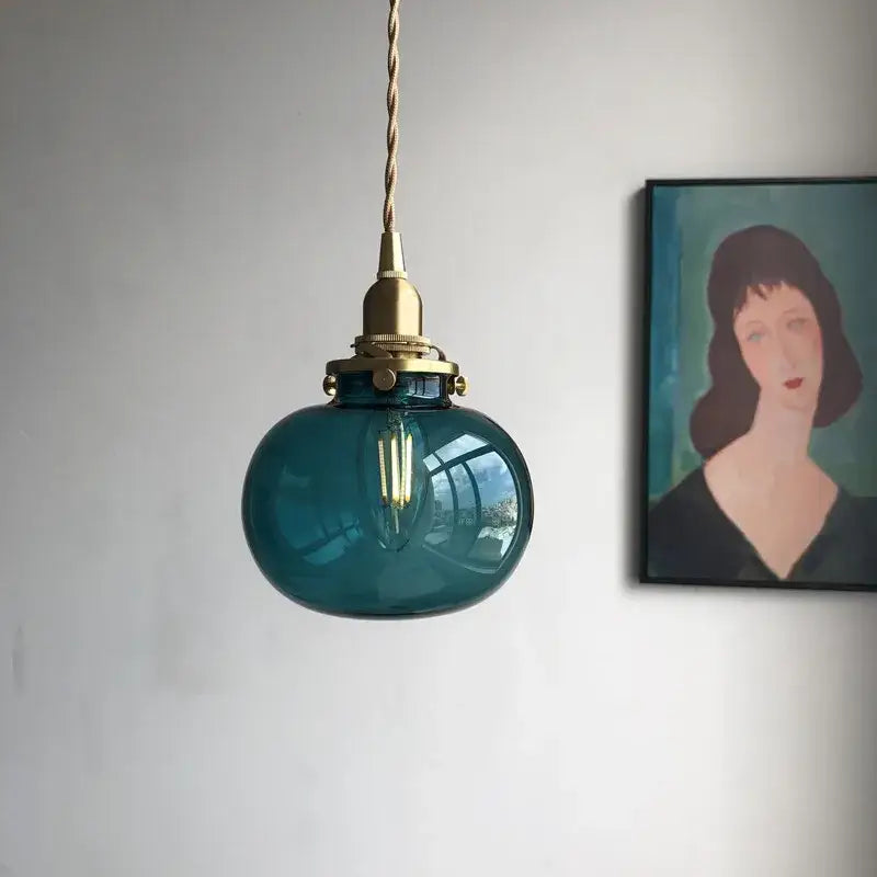 Teal glass ball pendant light with brass hardware and twisted cord by decorbites ideal for bedroom lighting decor