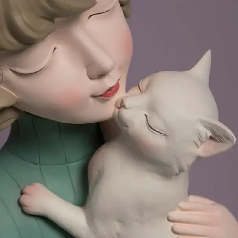 A delicate white ceramic bowknot cat girl figurine with blonde hair kissing a kitten for living room decorbites decor