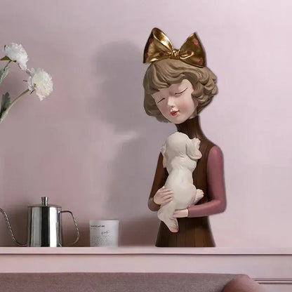 A resin bowknot cat girl figurine with a teal and gold bow holding a white puppy for living room decorbites decor