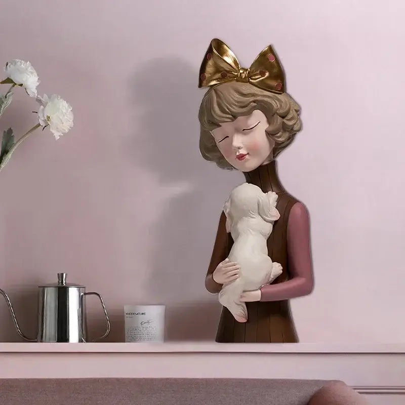 A resin bowknot cat girl figurine with a teal and gold bow holding a white puppy for living room decorbites decor