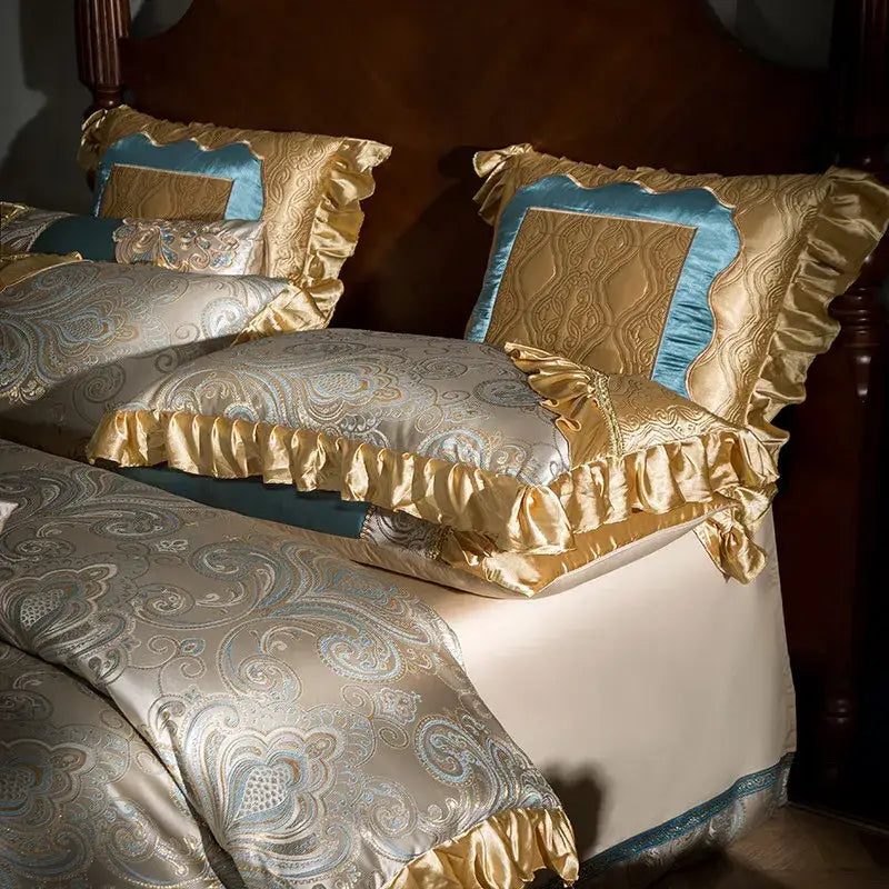 Luxurious teal and gold embroidered bedding set in 200s egyptian cotton with intricate paisley patterns and ruffled edges