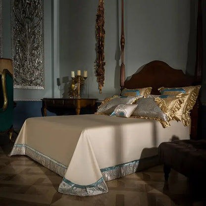 Cream-colored satin bedspread with silver and teal embroidered trim in teal and gold embroidered 200s egyptian cotton bedding set