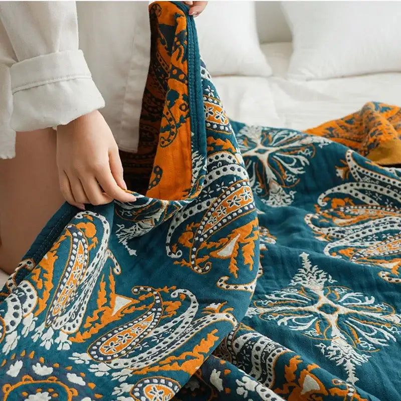 A plush teal and gold floral bohemia cotton blanket with paisley pattern and white accents for bedroom decorbites bohemia cotton