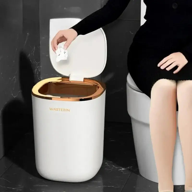 White cylindrical smart sensor luxury trash can with gold rim and wasterin branding for kitchen use