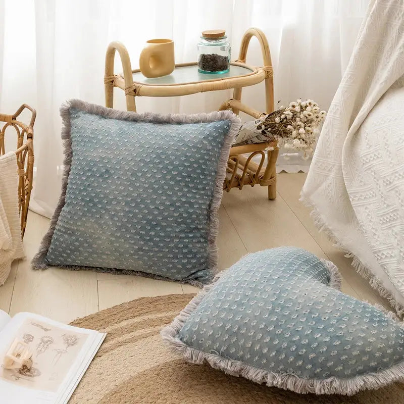 A soft light blue decorbites denim fringed cushion cover with textured dots and frayed edges for living room decor