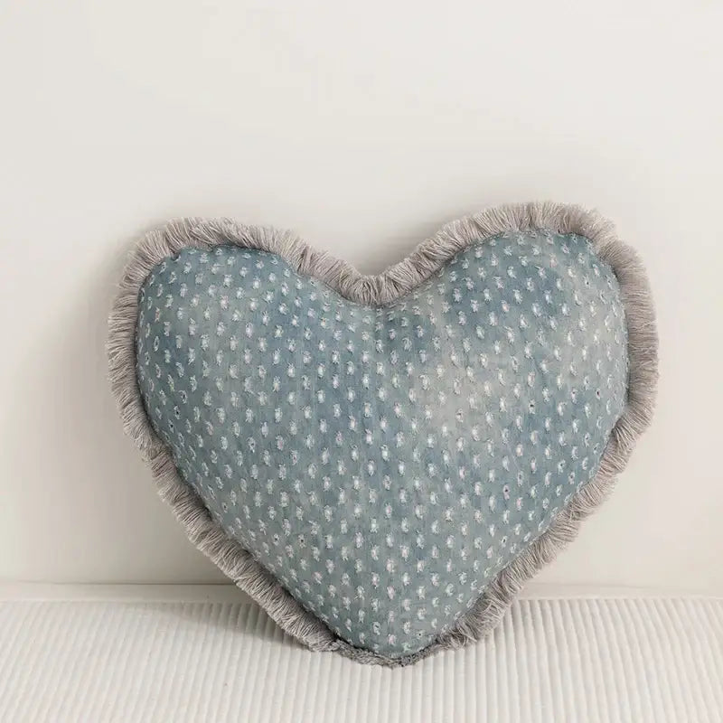A light blue heart-shaped cushion cover with subtle white dots and gray frayed edges from decorbites denim fringed collection
