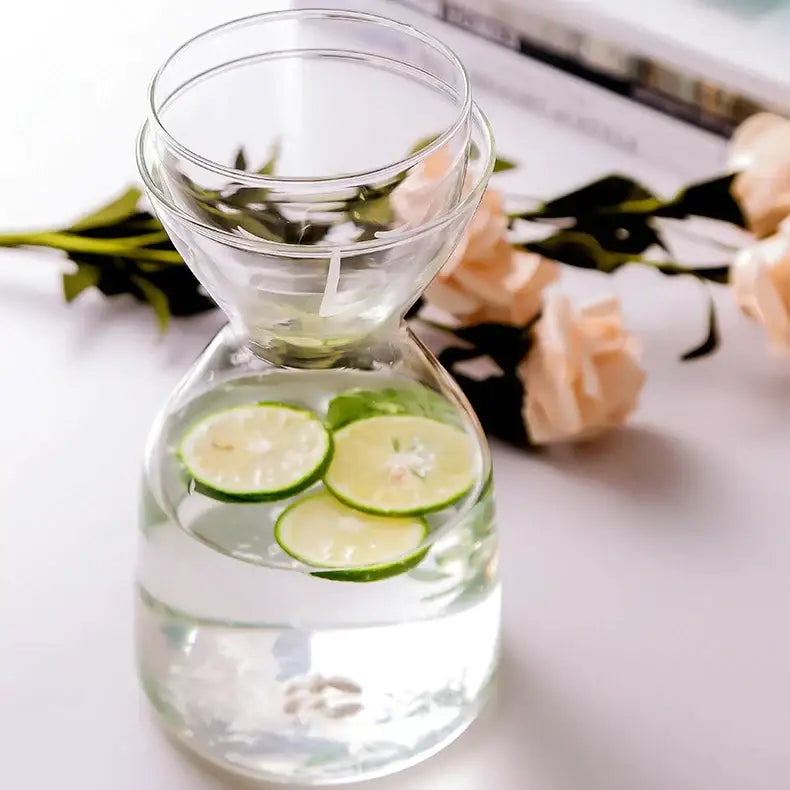 Teal hourglass glass tea infuser water bottle clear glass carafe with floating lime slices for kitchen use