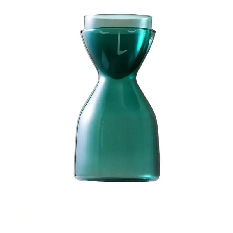 Teal hourglass glass tea infuser water bottle with a stylized face design made from decorbites glass tea material