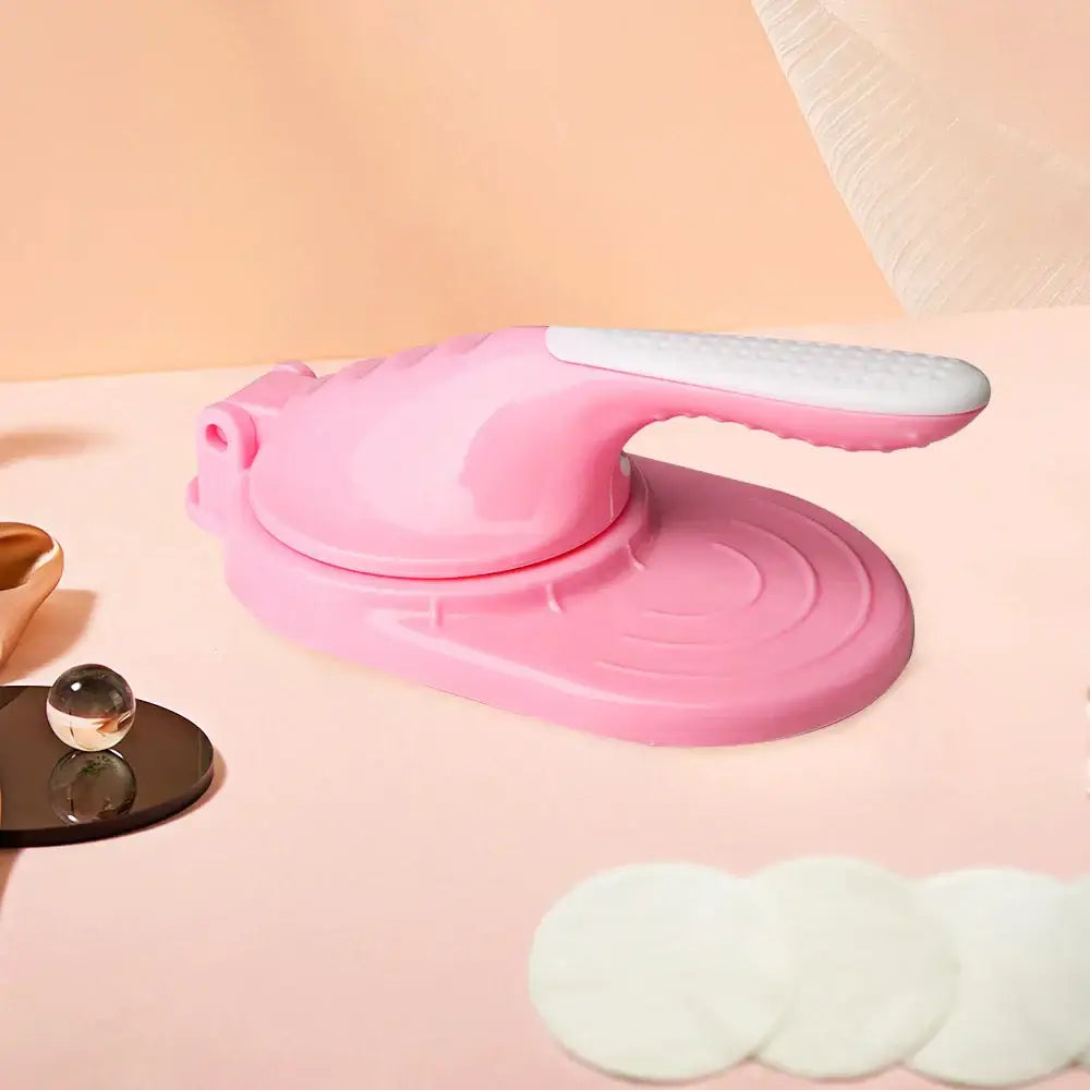 Pink plastic dumpling skin maker with white textured handle dough press tool for kitchen use