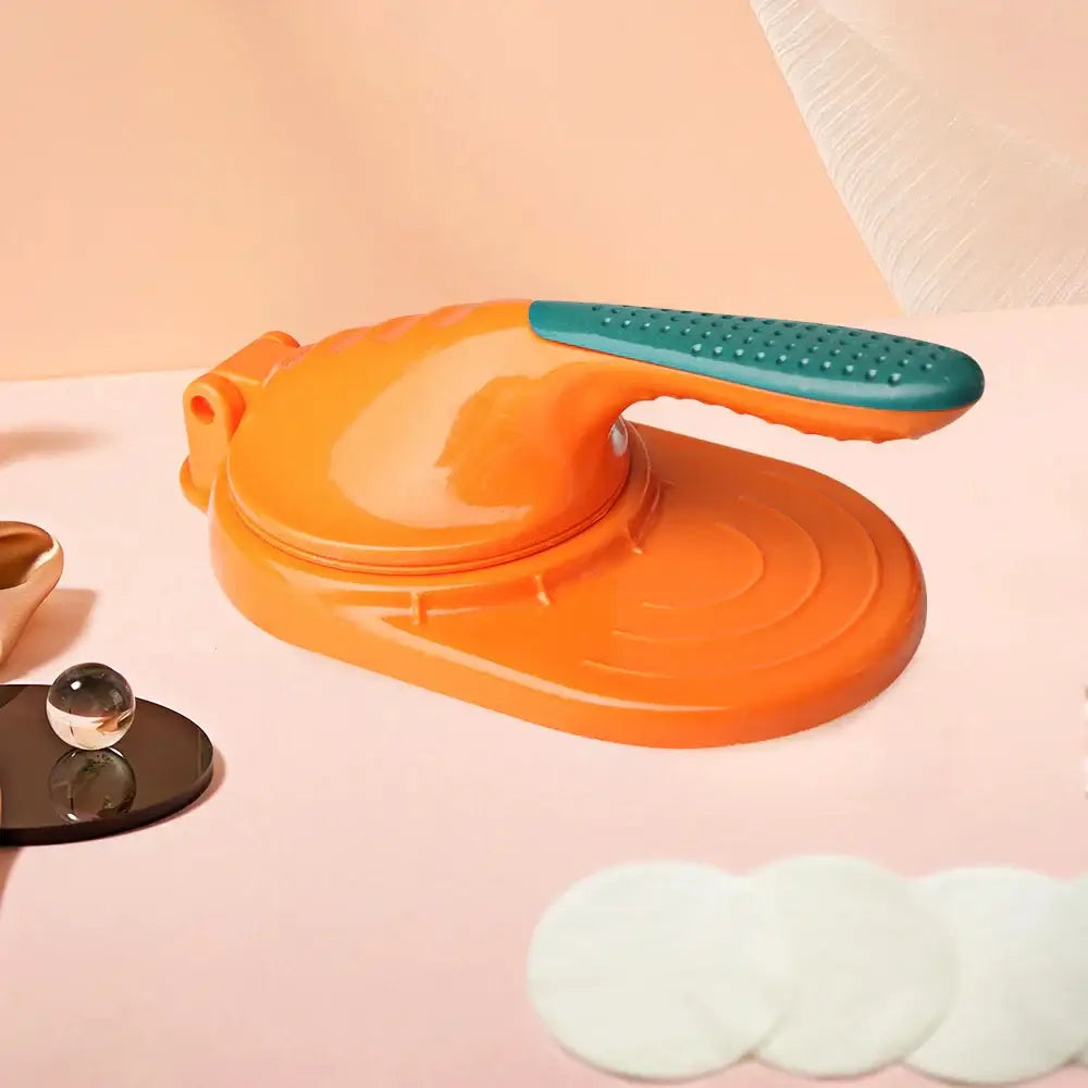 Vibrant orange plastic dough press tool with teal textured grip handle for efficient dumpling skin making