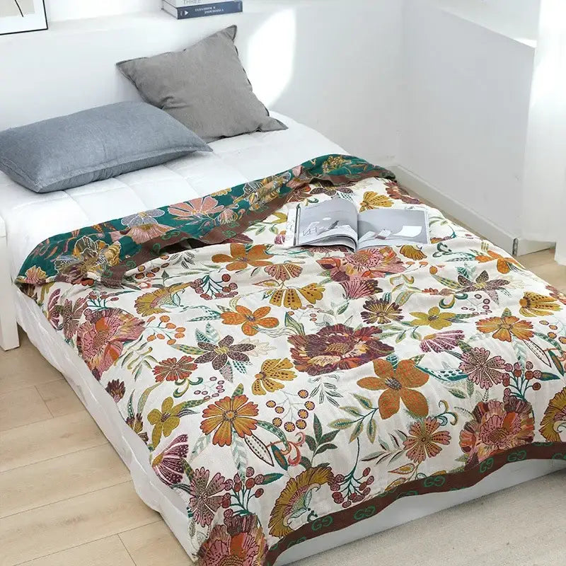 A cozy cream quilted blanket with vibrant floral pattern on white background decorbites geometric cotton gauze summer throw