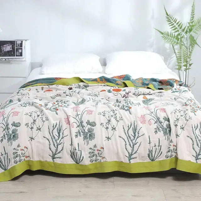 Off-white quilted botanical cotton gauze summer blanket with pink flowers and lime-green border from decorbites geometric cotton collection